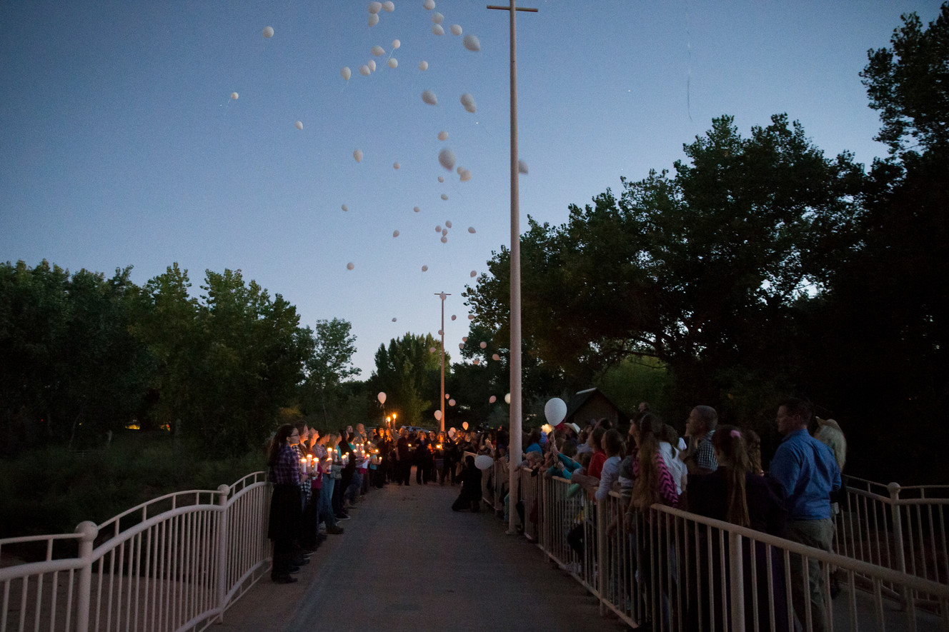 Balloons are released into the air during a memorial ceremony at Cottonwood Park in Colorado City, Arizona, on Wednesday, Sept. 14, 2016. The ceremony was held in remembrance of those killed in a flood one year ago. (Photo: Spenser Heaps, Deseret News)