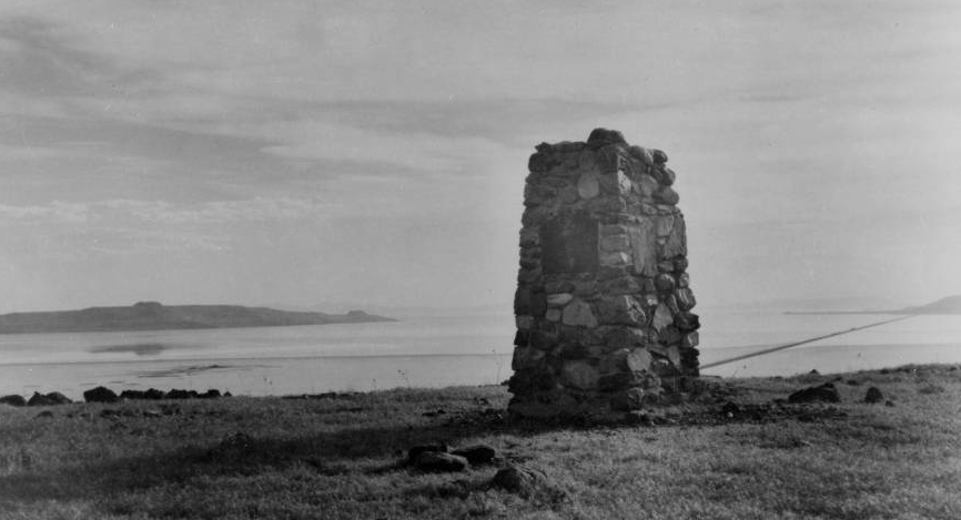 A photo of the John C. Fremont monument on top of Little Mountain, Fremont Island at left. Southern Pacific Railroad at right. (Photo: Utah State Historical Society)