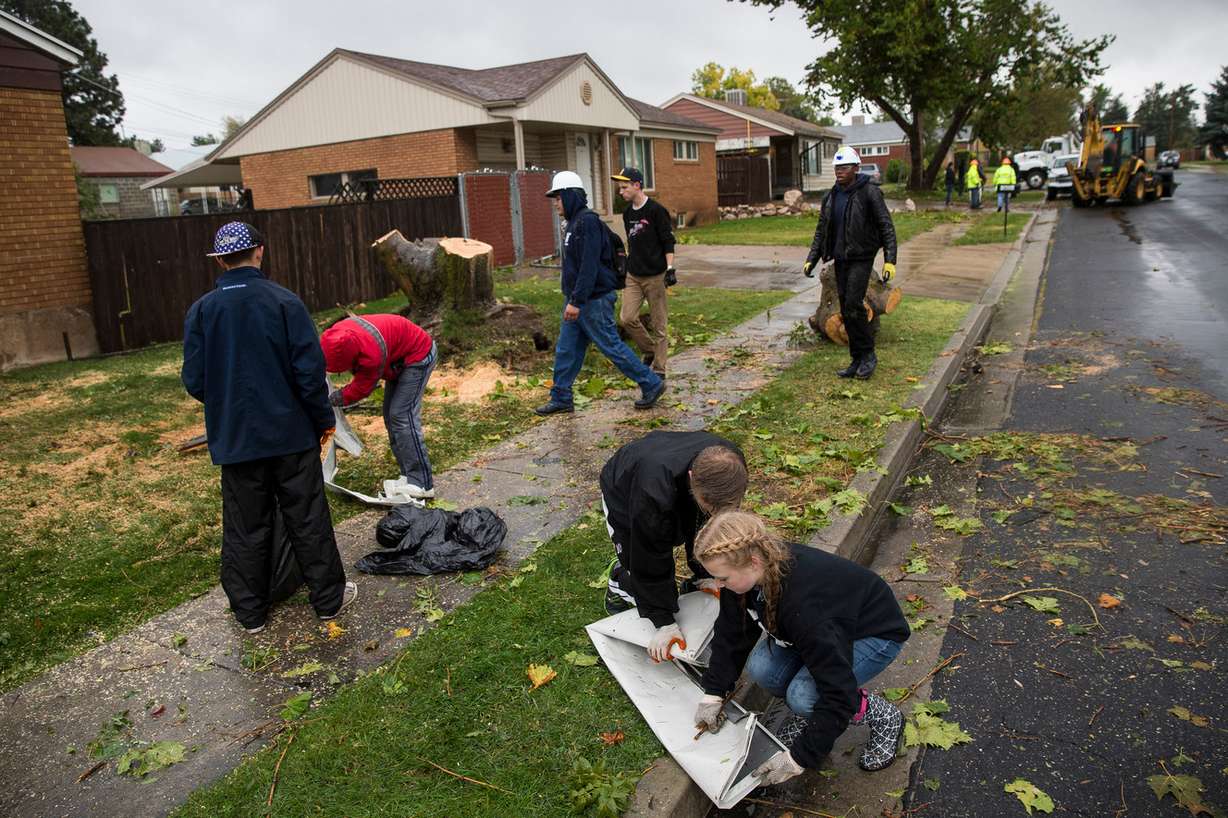 Tyler Staten, 17, and McKenna Linford, 17, work with other volunteers to clear debris in Washington Terrace on Friday, Sept. 23, 2016. Residents are recovering after a tornado swept through the area a day earlier. (Photo: Spenser Heaps, Deseret News)