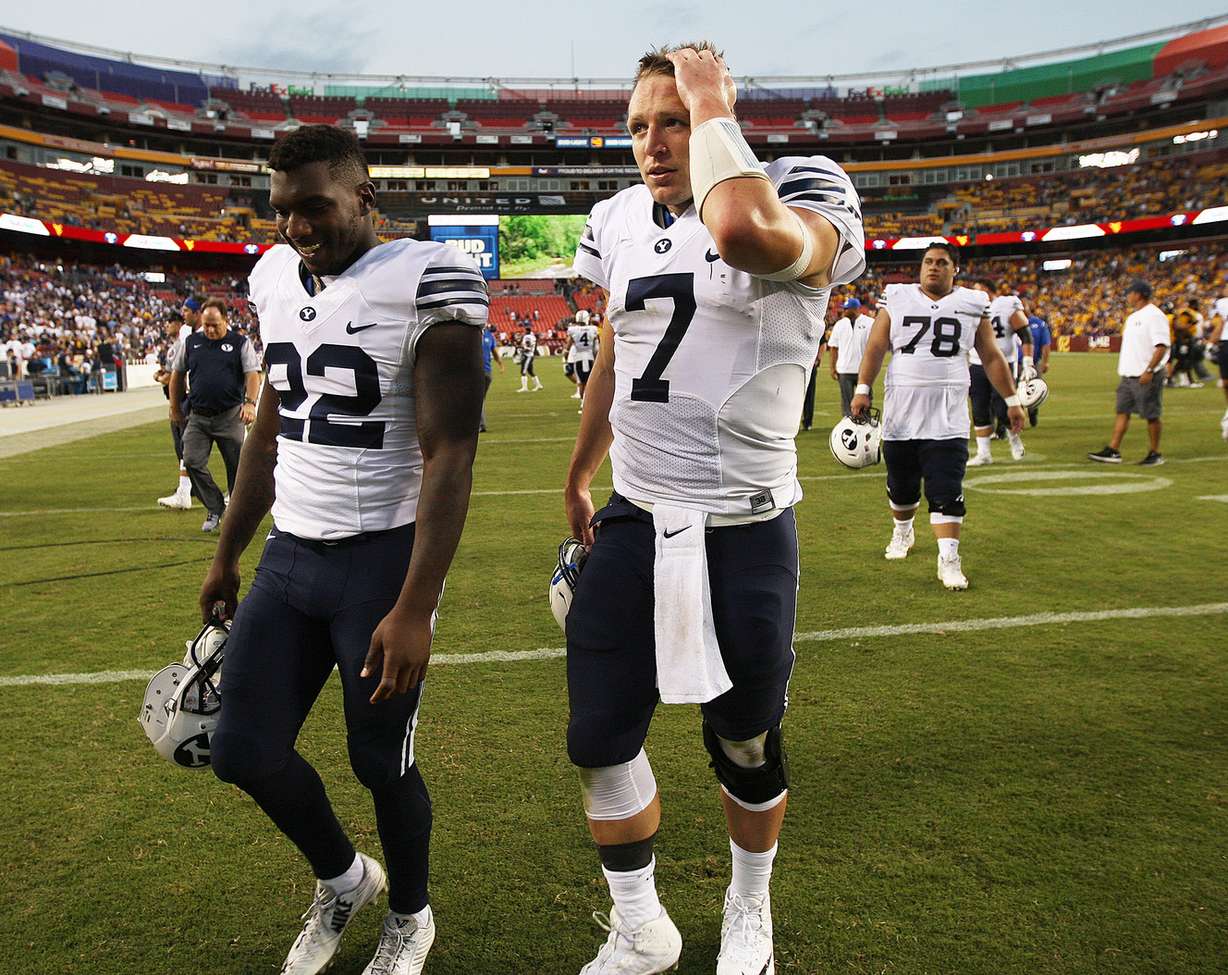 BYU quarterback Taysom Hill (7) and his teammates leave the field after the Cougars fell to West Virginia 35-32 at FedEx Field in Landover, Maryland on Saturday, Sept. 24, 2016. (Photo: Scott G Winterton, Deseret News)
