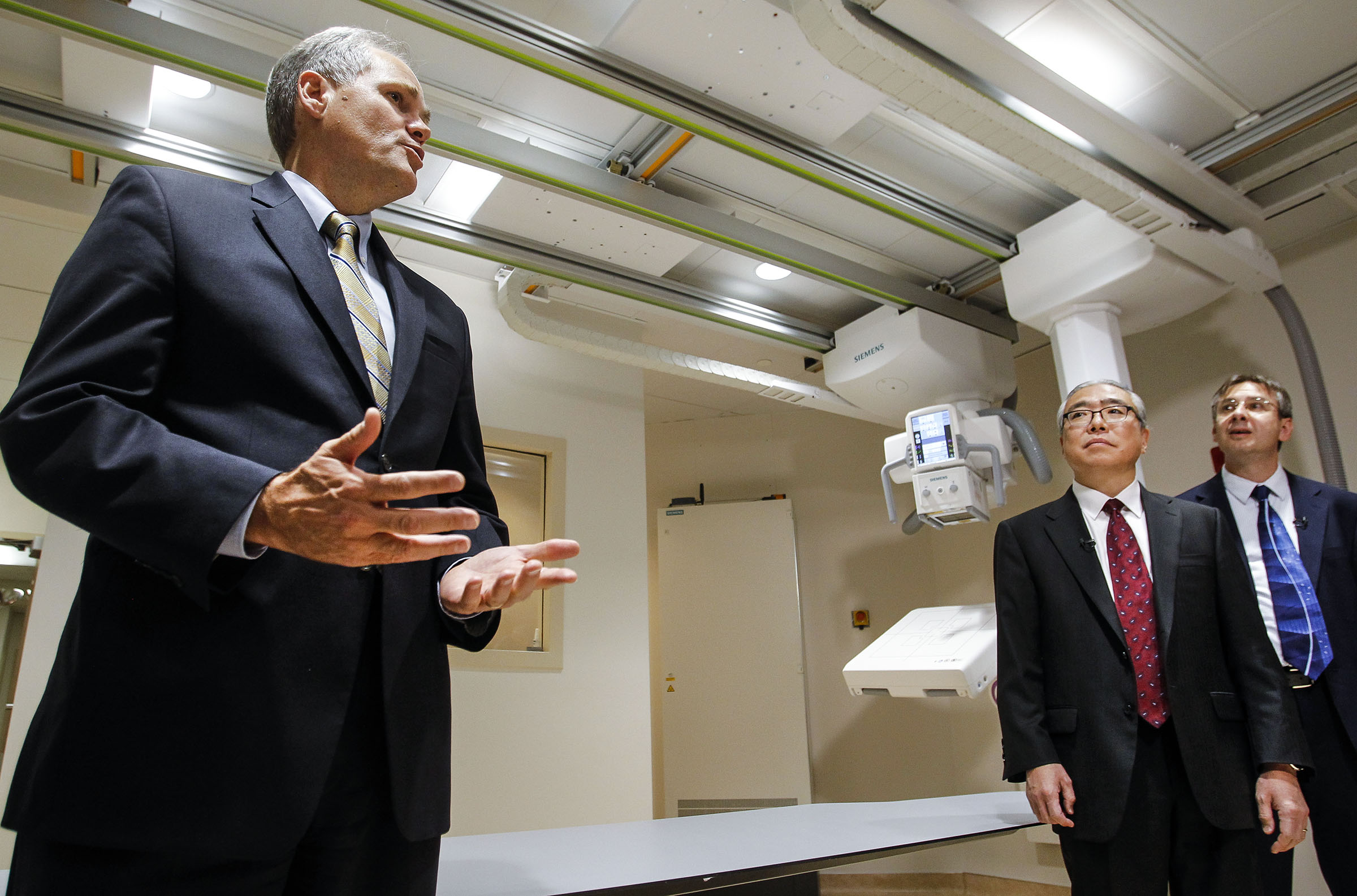 FILE - Quinn McKenna, chief operating officer of University of Utah Health Care, left, welcomes attendees as the unveiling of the new Multitom Rax Twin Robotic X-Ray System at the University Hospital's radiology department in Salt Lake City on Friday, July 15, 2016. (Photo: Weston Kenney, Deseret News, File)