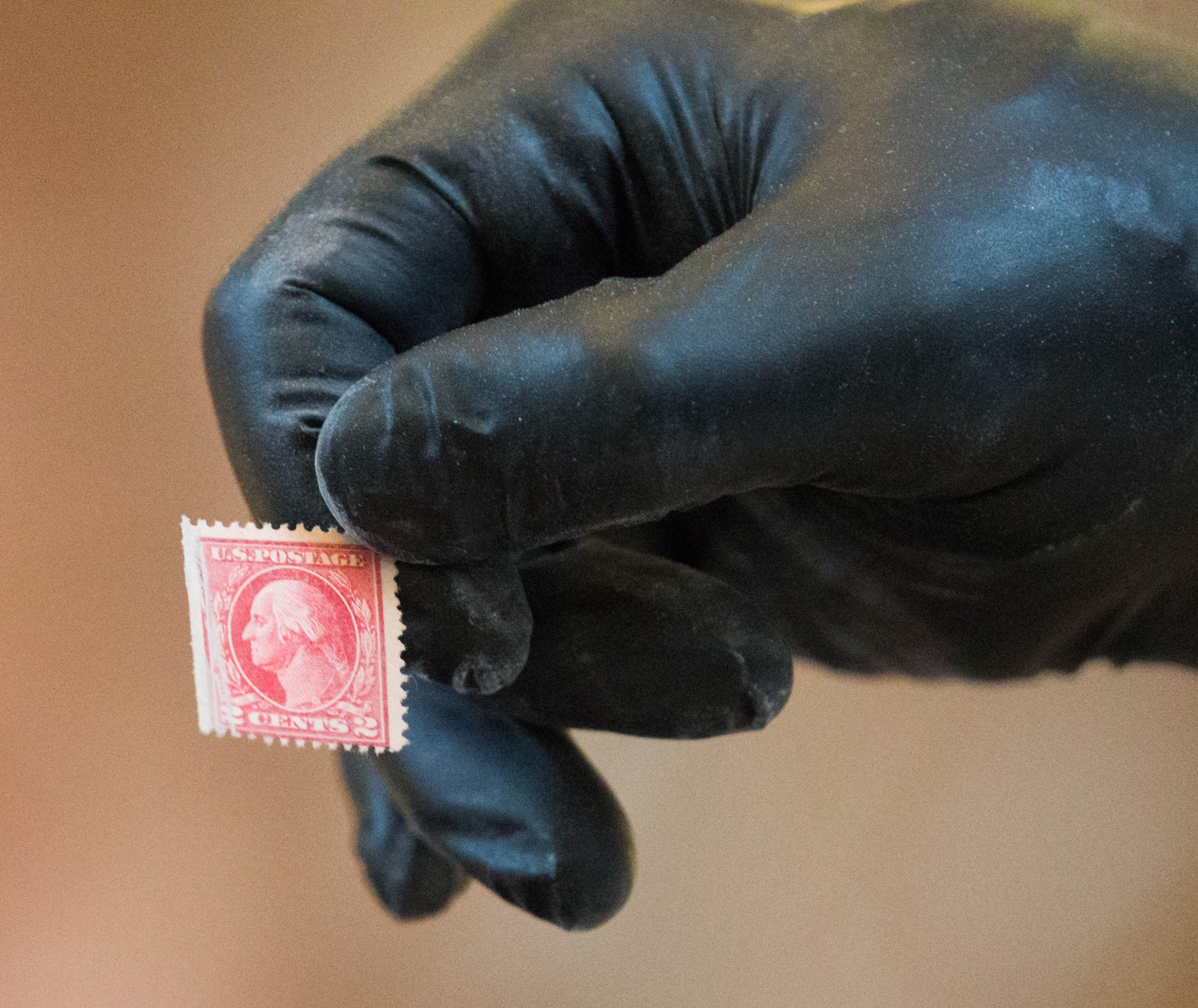 A $.02 stamp was part of the contents found as Governor Gary R. Herbert opens a 100 year old time capsule that was removed from the capitol earlier during a ceremony in to rotunda on Monday, Oct. 3, 2016. (Photo: Scott G. Winterton, Deseret News)