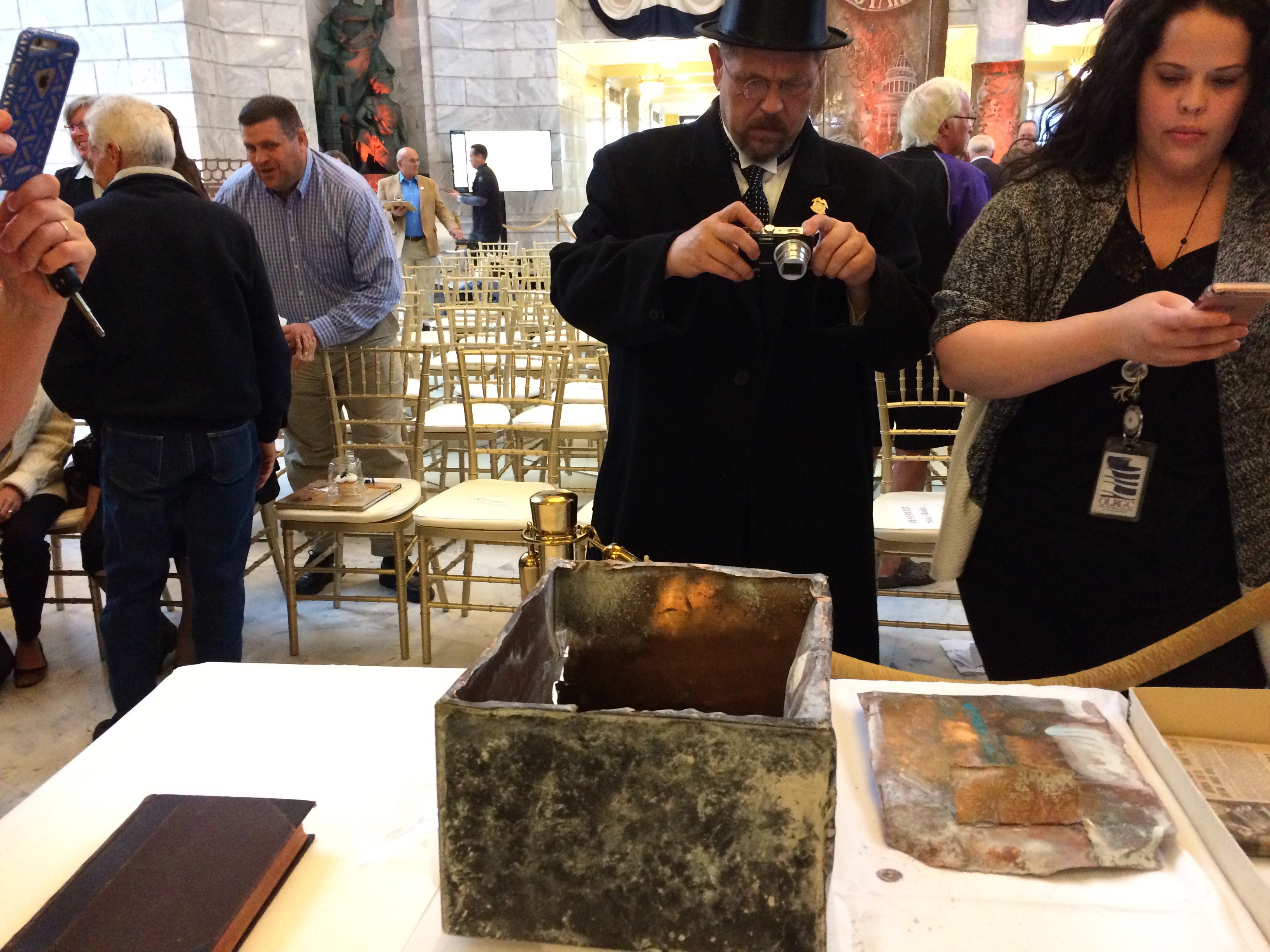 A man dressed up as former Utah governor Williams Spry takes a photo of the 1914 time capsule (Photo: Carter Williams, KSL)