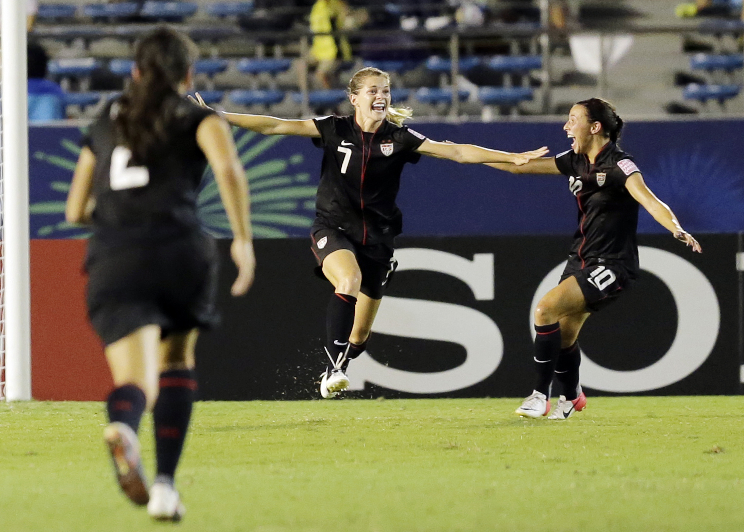 Kealia Ohai of Draper, center, celebrates with Vanessa Di Bernardo (10) after she scored a goal during the final match of the U-20 Women's World Cup against Germany in Tokyo, Saturday, Sept. 8, 2012. (AP Photo/Koji Sasahara)