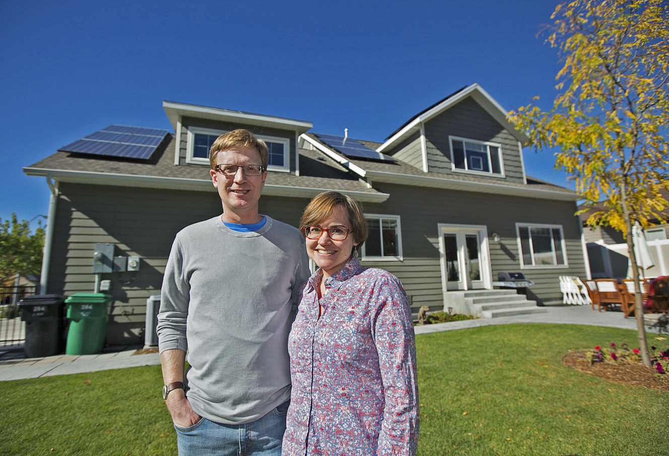 Nick Mason with his wife, Stacie, stand outside their Provo home on Friday, Oct. 7, 2016. Roughly 80 percent of their electric bill is paid for by solar energy. Clean energy advocates will be affected by a recent vote by Provo leaders to assess a net metering fee on municipal power customers. (Photo: Hans Koepsell, Deseret News)
