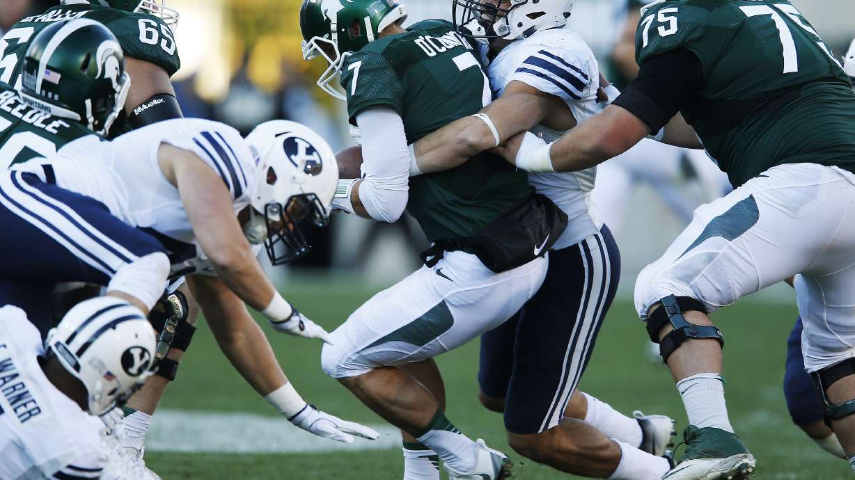 Brigham Young Cougars linebacker Sae Tautu (31) sacks Michigan State Spartans quarterback Tyler O'Connor (7) in East Lansing, MI on Saturday, Oct. 8, 2016. BYU won 31-14.