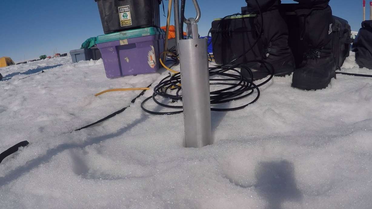 An apparatus is pulled up from a vertical hole the team bored into the ice sheet. Photo: Olivia Miller