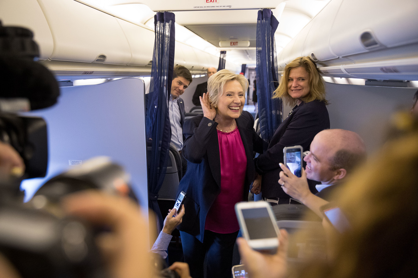Democratic presidential candidate Hillary Clinton, accompanied by traveling press secretary Nick Merrill, left, and director of communications Jennifer Palmieri, right, listens to a question from a member of the media as her campaign plane prepares to take off at Westchester County Airport in Westchester, N.Y., Tuesday, Sept. 6, 2016. Photo: Andrew Harnik, AP Photo