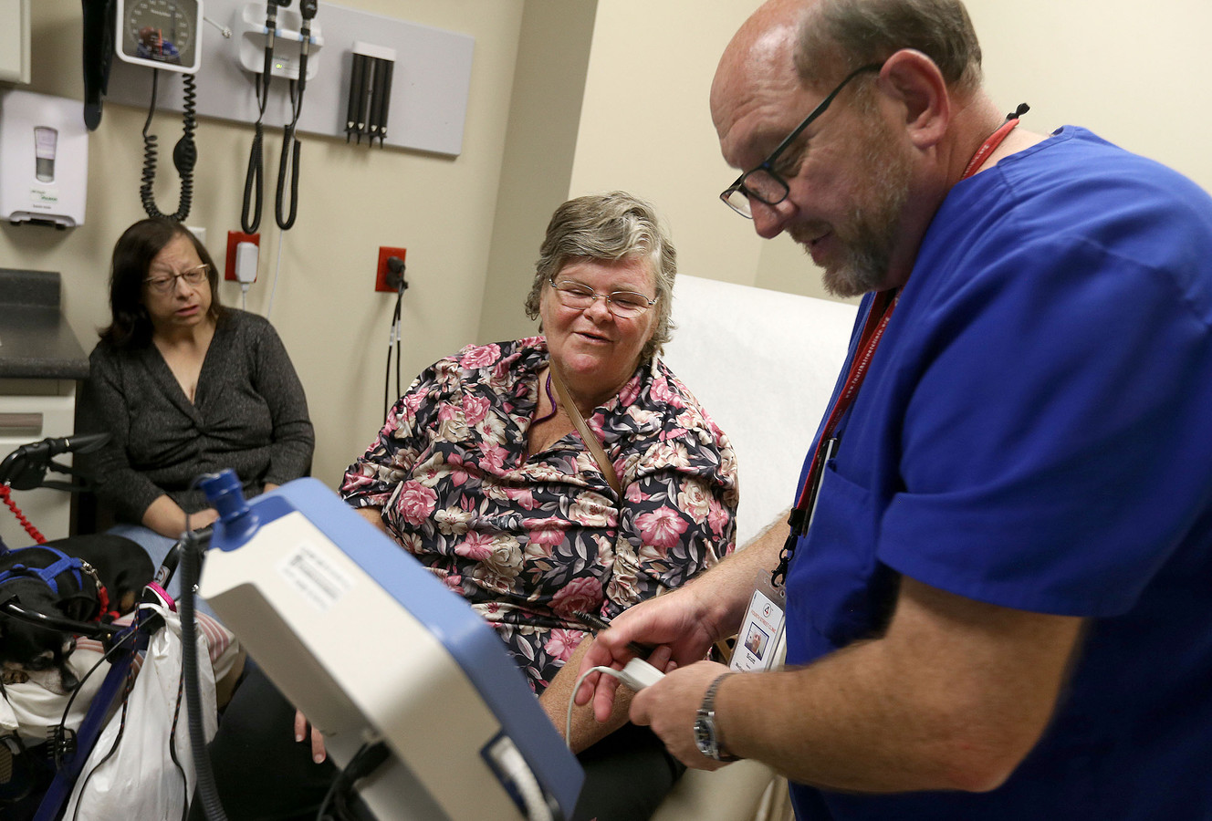 Diana Toohey, left, listens as Shannon Walch speaks with medical assistant Scott Taylor at the Fourth Street Clinic in Salt Lake City on Wednesday, Oct. 12, 2016. (Photo: Laura Seitz, Deseret News)