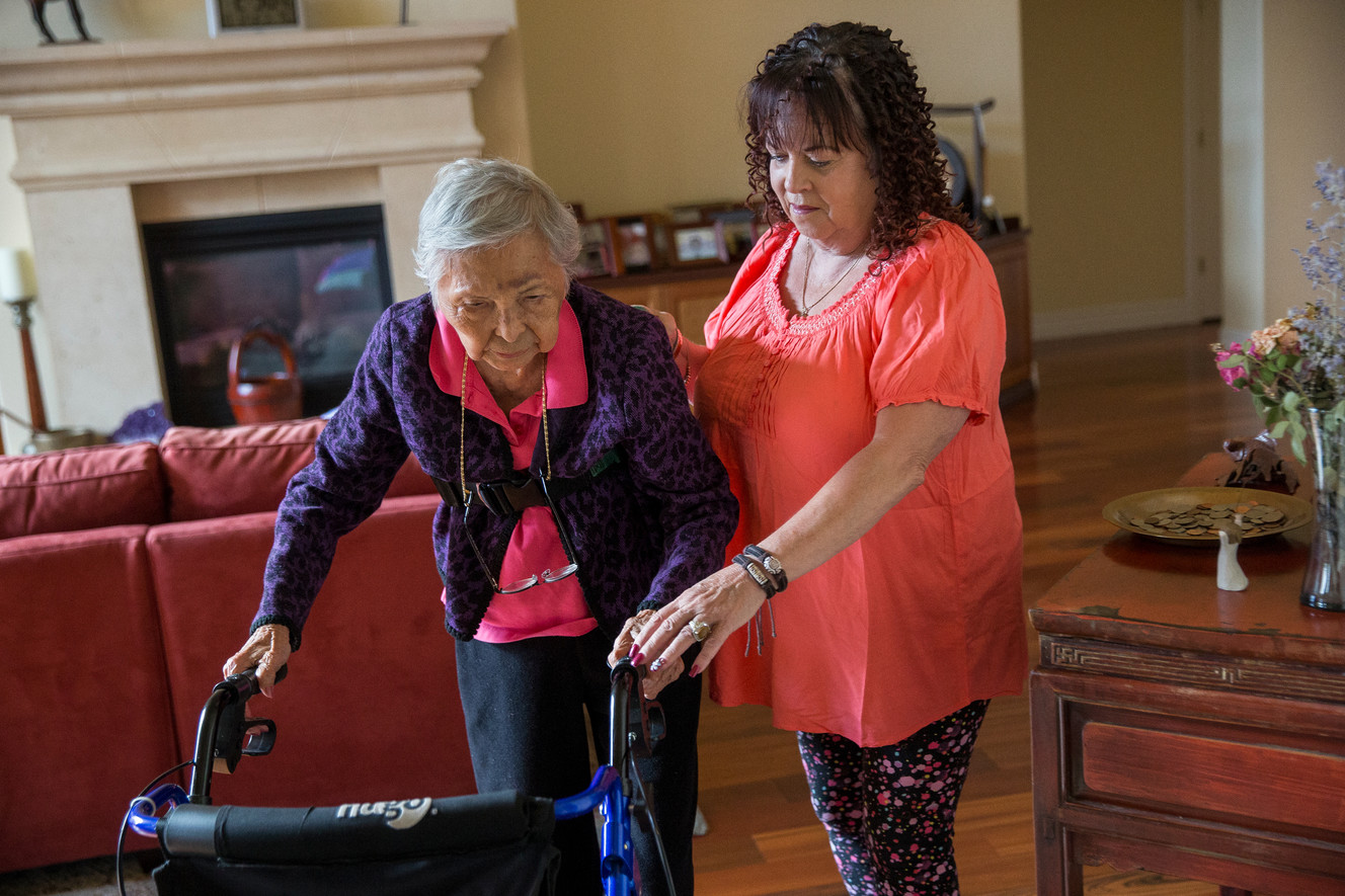 Mary Kawakami, 103, gets a helping hand from her longtime friend and caregiver Pat Rockling as they prepare to leave their home in Highland to go to lunch on Wednesday, Oct. 12, 2016. Photo: Spenser Heaps, Deseret News