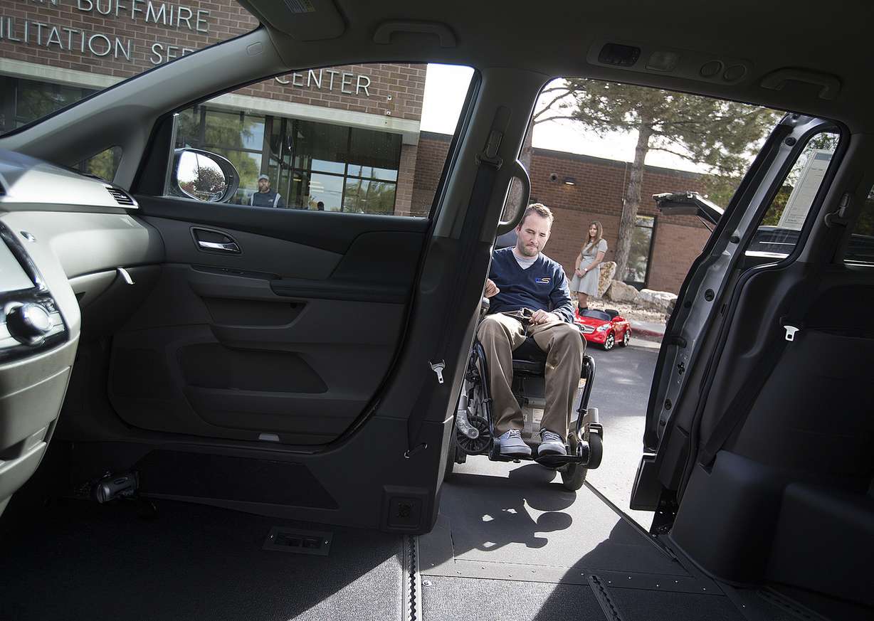 Dustin Godnick enters a minivan that has been adapted for wheelchair accessibility at the Utah Center for Assistive Technology's open house in Salt Lake City on Thursday, Oct. 13, 2016. (Photo: Laura Seitz, Deseret News)