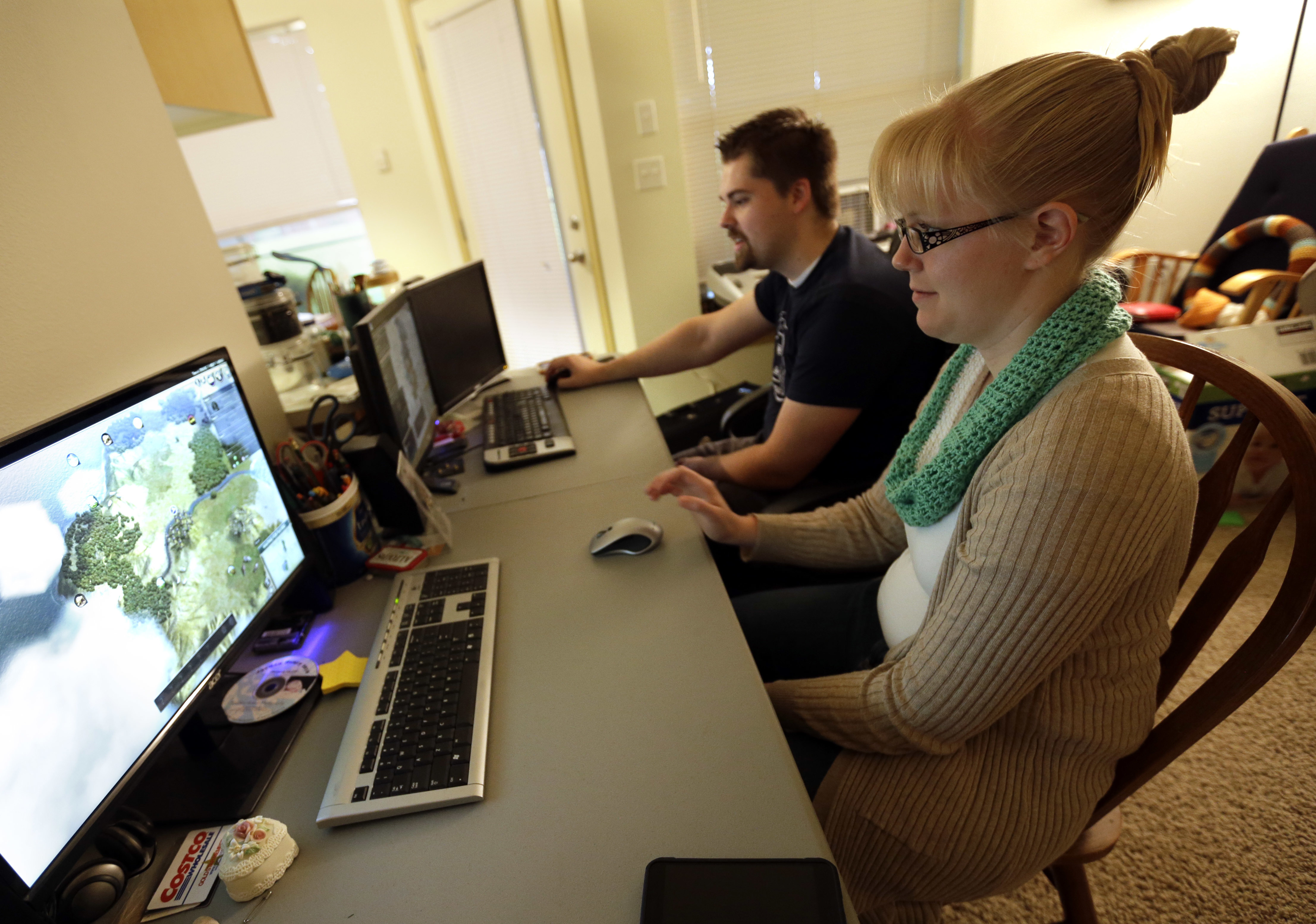 In this Thursday, Oct. 13, 2016, photo, Shavonne Henry, right, plays "Civilization", a computer game where you create civilizations, with husband Michael Henry, at their apartment in Vancouver, Wash. Photo: Don Ryan, AP Photo