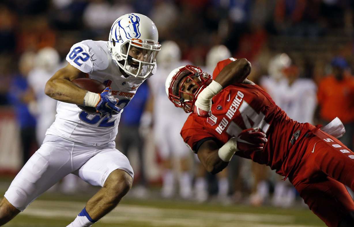 Boise State wide receiver Thomas Sperbeck (82) avoids a tackle by New Mexico safety Daniel Henry during the first half of an NCAA college football game in Albuquerque, N.M., Friday, Oct. 7, 2016. (Photo: Andres Leighton, AP Photo)