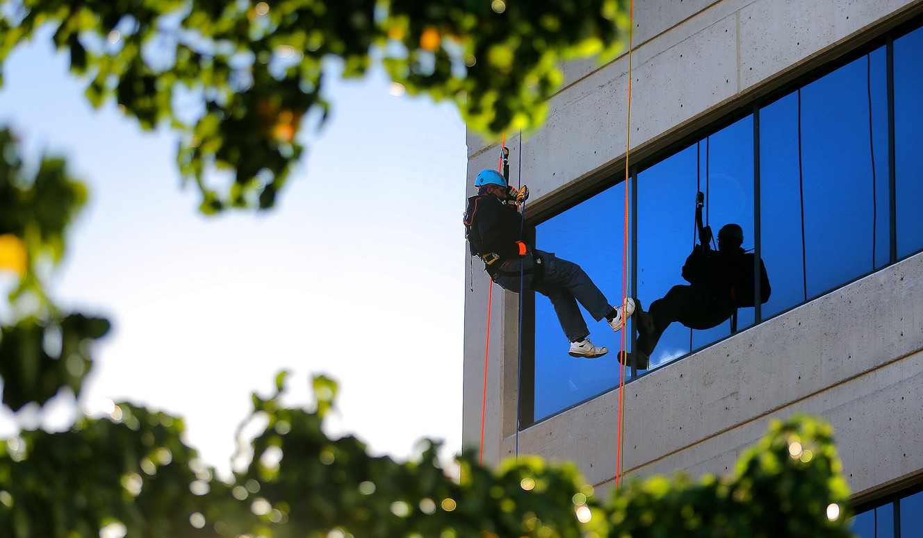 GR Robinson, rappels off the Maverik base camp building in Salt Lake City on Friday, Oct. 21, 2016. (Photo: Scott G Winterton, Deseret News)