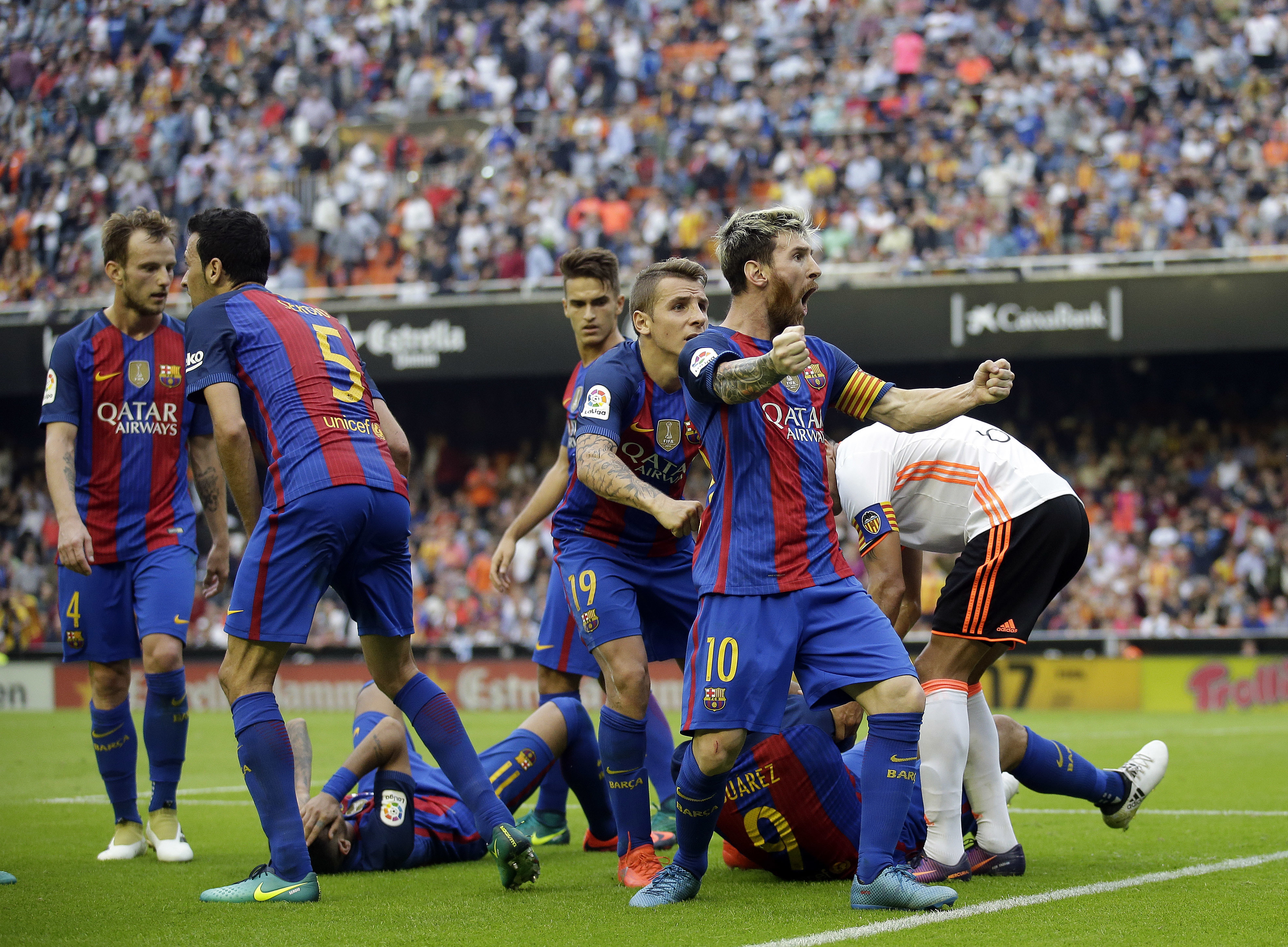 Iniesta injured, Messi scores 2 as Barca beats Valencia 3-2
