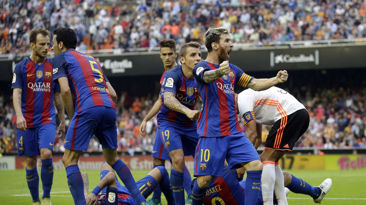 Iniesta injured, Messi scores 2 as Barca beats Valencia 3-2