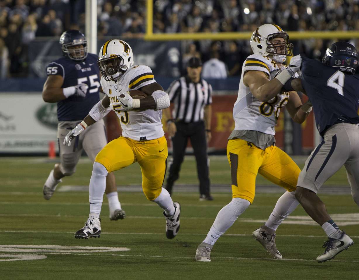 Wyoming running back Brian Hill runs against Nevada in the first half of an NCAA college football game in Reno, Nev., Saturday, Oct. 22, 2016. (AP Photo/Tom R. Smedes)