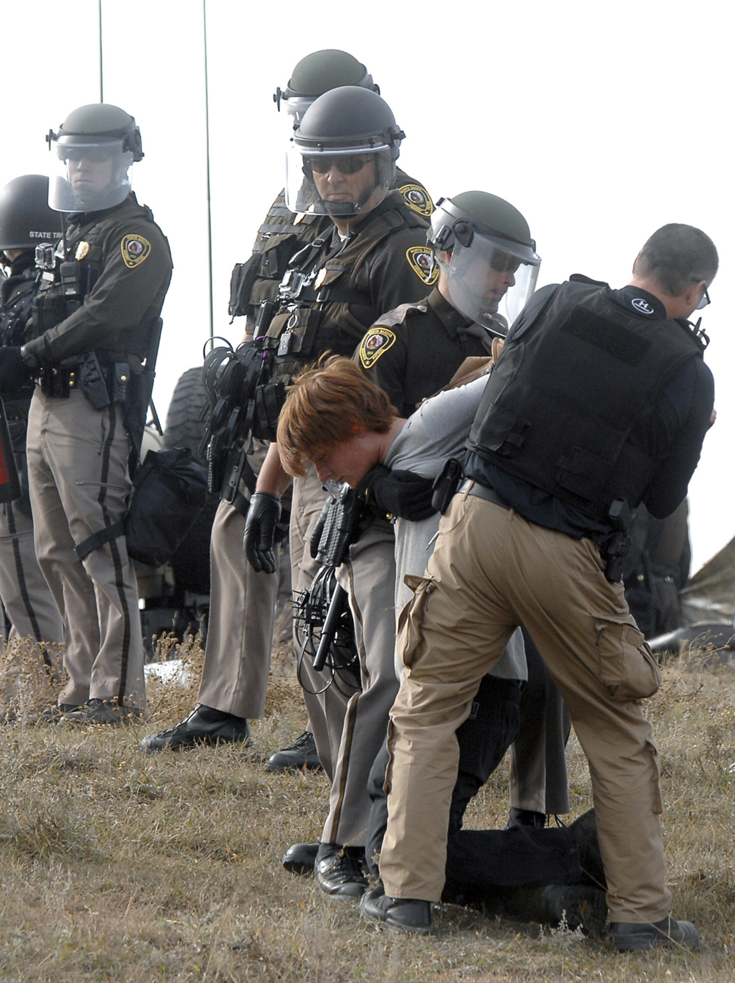 An unidentified Dakota Access Pipeline protester is arrested inside the Front Line Camp as law enforcement surround the camp to remove the protesters from the property and relocated to the overflow camp a few miles south of Highway 1806 in Morton County, N.D., Thursday, Oct. 27, 2016. (Mike McCleary, The Bismarck Tribune via AP)