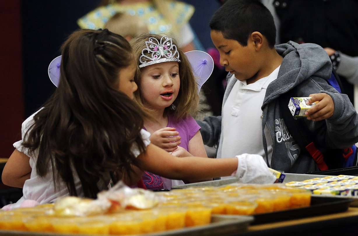 Andrea, left, Hailey and Diego choose their food during the Breakfast in the Classroom program at Backman Elementary School in Salt Lake City on Friday, Oct. 28, 2016. (Photo: Ravell Call, Deseret News)