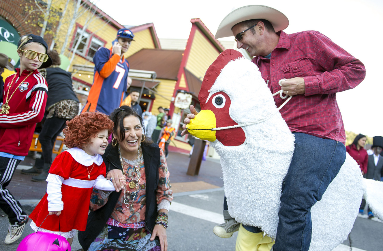 Annie Perret, left, dressed as Annie, and her mom, Lisa Saturnino, laugh at Todd Potasky's costume in Park City on Monday, Oct. 31, 2016. Potasky recently moved to Utah with his wife, Kris, and his chicken costume made the cut for space in a small moving pod. Hundreds of people decked out in costumes paraded among each other and their dogs during the city's annual Halloween on Main Street event. (Photo: Nick Wagner, Deseret News)