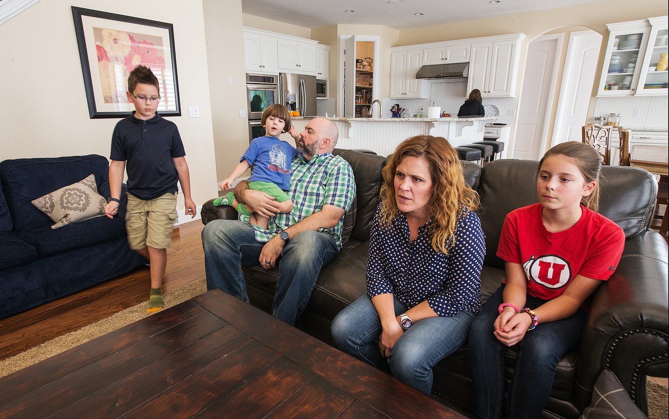 Trey and Heidi Wallis sit with their kids, Bubba, left, Louie, on Trey's lap, Sam, in the kitchen, and Ellie as they talk about why they are fighting to have GAMT screening placed on the national newborn screening list during an interview in their Bluffdale home on Wednesday, Nov. 2, 2016. Louie and Sam have the rare disease guanidinoacetate methyltransferase (GAMT) deficiency. (Photo: Scott G Winterton, Deseret News)