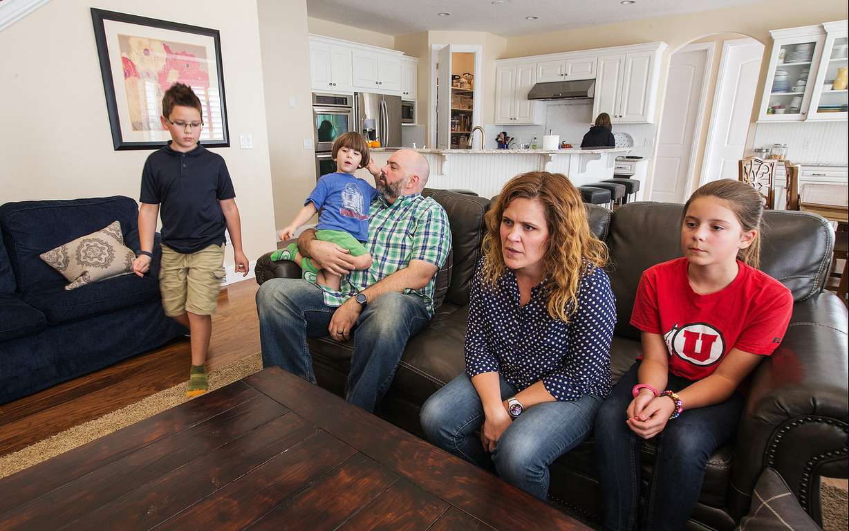 Trey and Heidi Wallis sit with their kids, Bubba, left, Louie, on Trey's lap, Sam, in the kitchen, and Ellie as they talk about why they are fighting to have GAMT screening placed on the national newborn screening list during an interview in their Bluffdale home on Wednesday, Nov. 2, 2016. Louie and Sam have the rare disease guanidinoacetate methyltransferase (GAMT) deficiency. (Photo: Scott G Winterton, Deseret News)