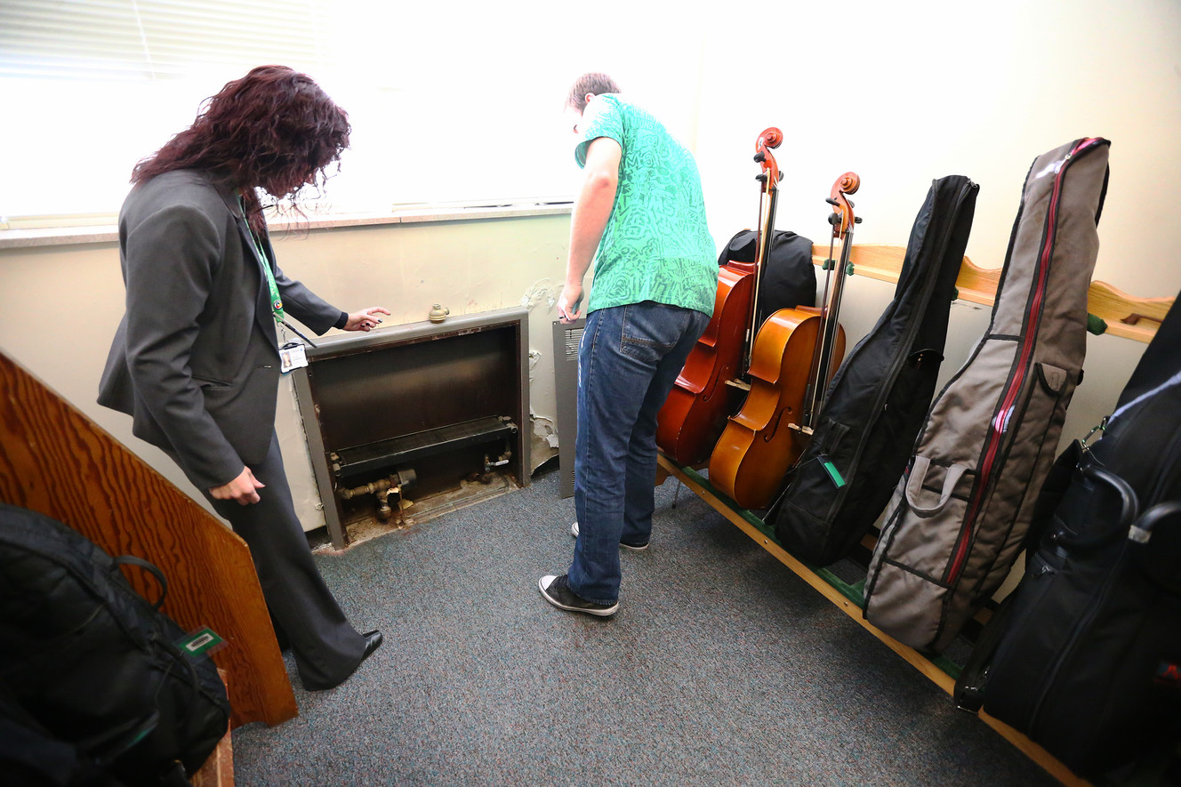 Dixie Garrison, principal of West Jordan Middle School, points to an area where a steam pipe burst and nearly destroyed several student instruments during a tour of the aging facility on Friday, Nov. 4, 2016. During the tour, Garrison discussed why she and other Jordan School District officials would like a $245 million bond to pass on Nov. 8. West Jordan Middle is one school that would be rebuilt if the bond passes. (Photo: Scott G Winterton, Deseret News)