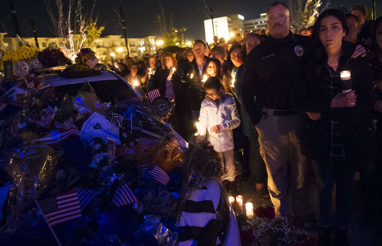 Hundreds of people hold candles around a squad car memorial during a vigil for fallen West Valley City police officer Cody Brotherson in West Valley City on Wednesday, Nov. 9, 2016. (Photo: Nick Wagner, Deseret News)