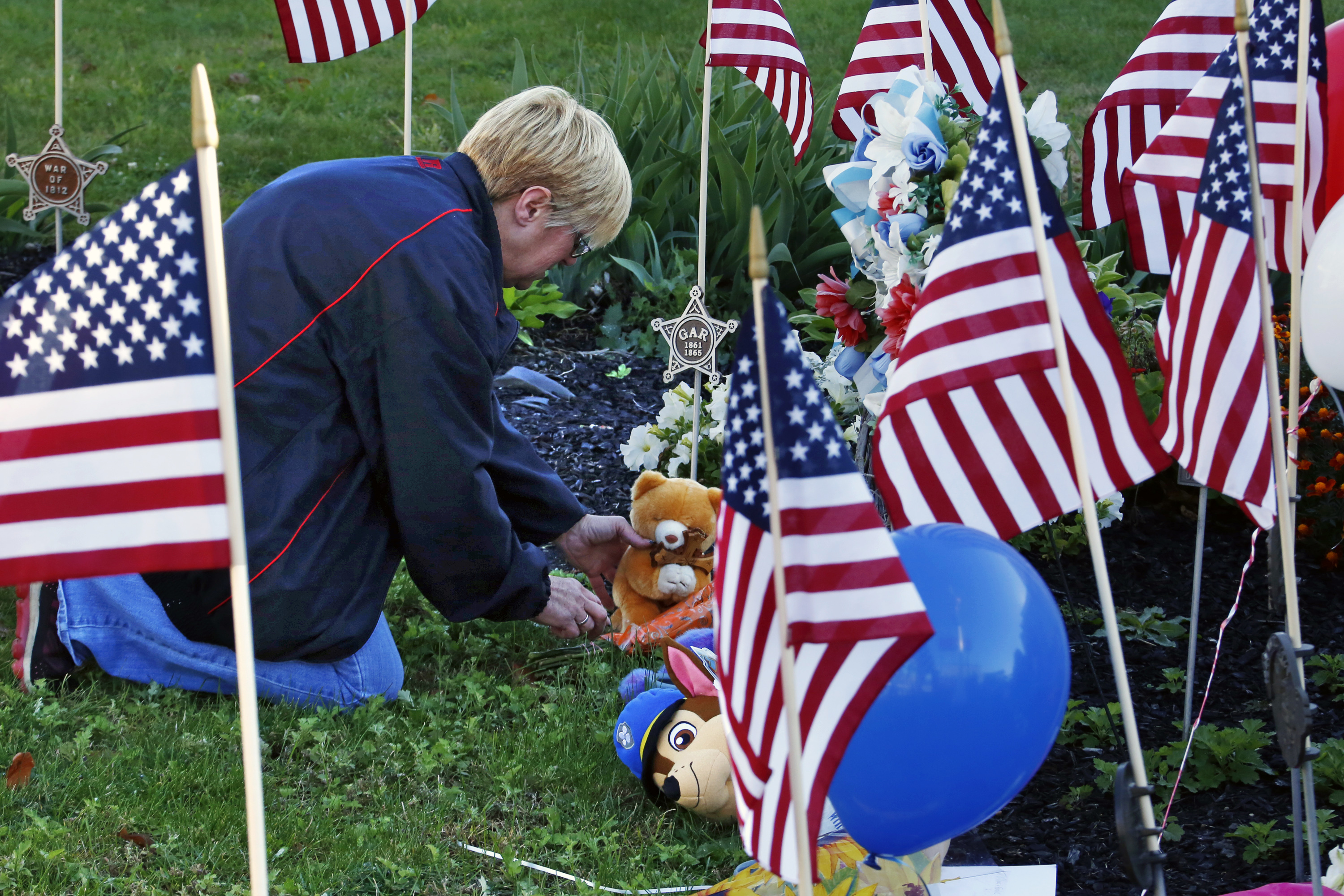 The Latest: Coroner: Woman killed by man who ambushed cops