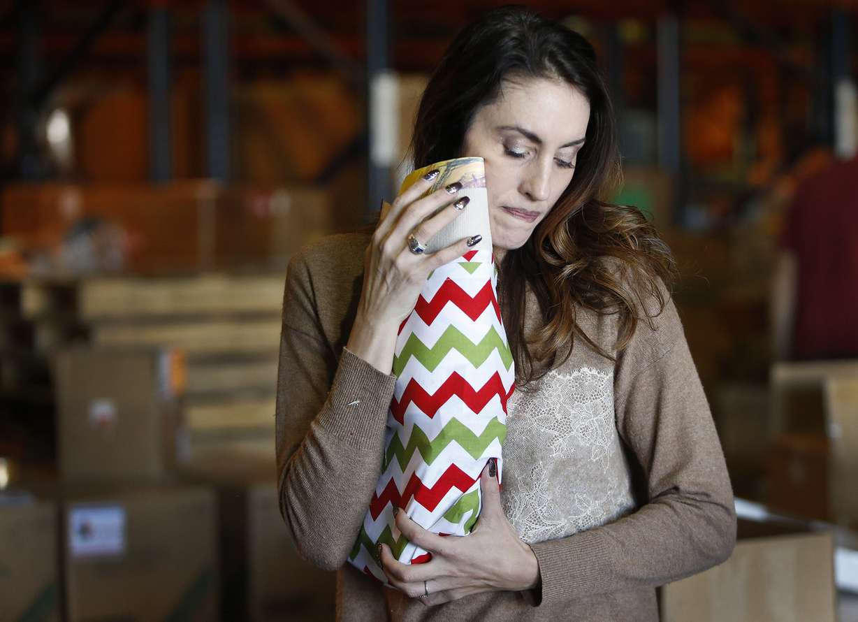 Carolyn Norris hugs and kisses each stocking she stuffs as volunteers fill more than 10,000 Christmas stockings in support of Operation Christmas Stocking in Salt Lake City on Friday, Nov. 11, 2016. (Photo: Jeffrey D. Allred, Deseret News)