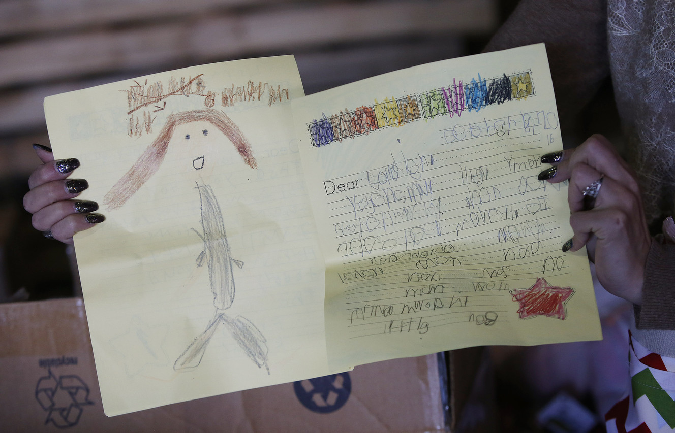 Children's letters are included as volunteers stuff more than 10,000 Christmas stockings in support of Operation Christmas Stocking in Salt Lake City on Friday, Nov. 11, 2016. (Photo: Jeffrey D. Allred, Deseret News)