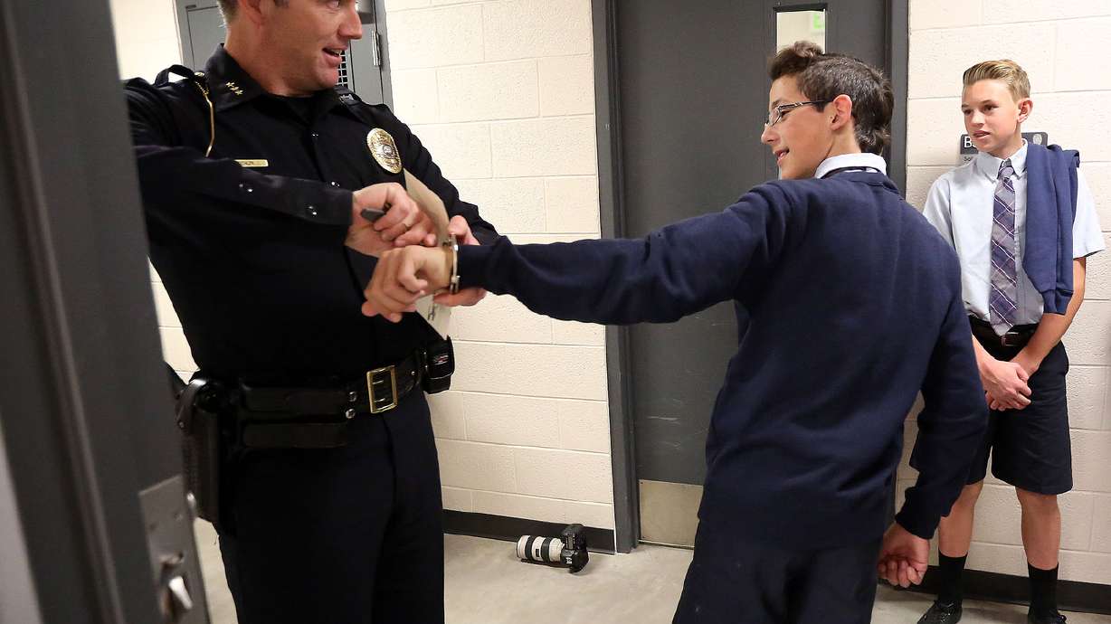 Sign of peace: Catholic school students acknowledge Bountiful police as peacekeepers