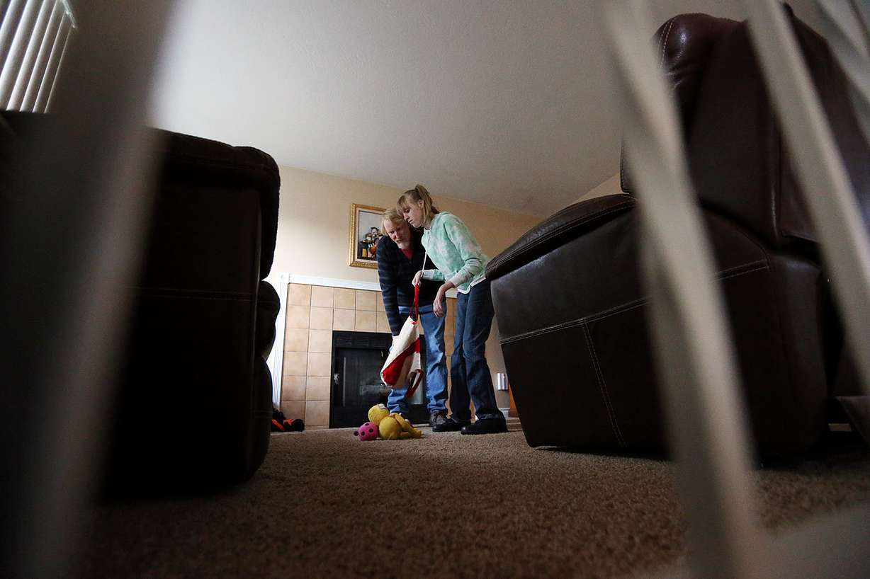 Doug Rice picks up toys with his daughter, Ashley, at their home in West Jordan on Wednesday, Nov. 16, 2016. (Photo: Ravell Call, Deseret News)