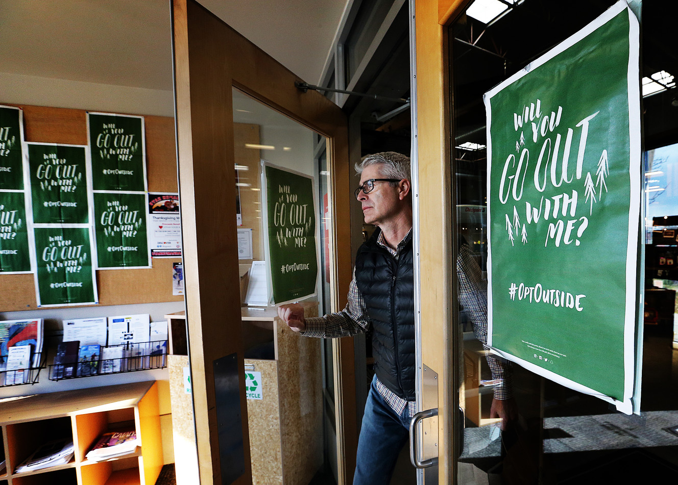 Ron Kramer walks by #OptOutside signs as leaves REI in Sandy on Thursday, Nov. 17, 2016. Photo: Ravell Call, Deseret News