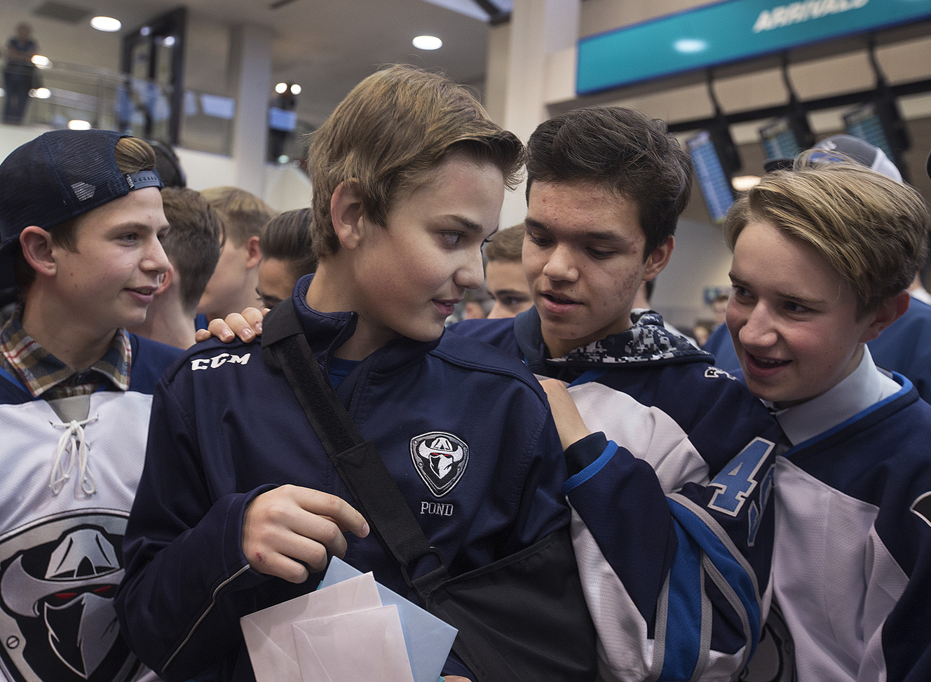 Karsen Wight, second from left, is welcomed home by his West Coast Renegade hockey teammates, Daniel Gerling, far left, and Diego Contreras and Porter Templin at the Salt Lake City International Airport on Friday, Nov. 18, 2016. Photo: Laura Seitz, Deseret News