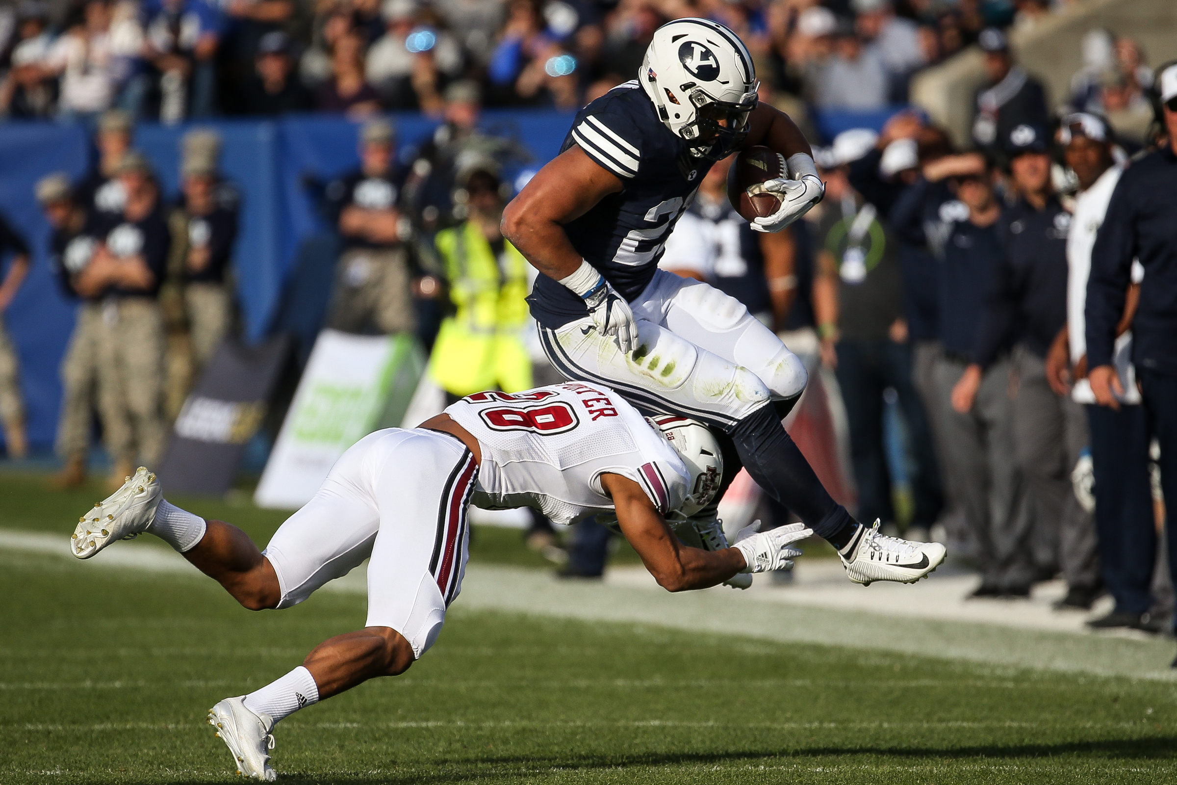 BYU tailback KJ Hall (20) is tackled by UMass cornerback Jackson Porter (28) during a game at LaVell Edwards Stadium in Provo on Saturday, Nov. 19, 2016. (Photo: Spenser Heaps, Deseret News)