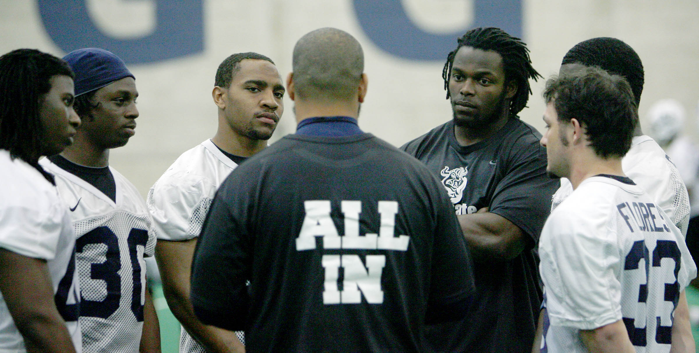 Running backs Coach Ilaisa Tuiaki (CQ) talks with his players including Injured player Robert Turbin (right center facing) during Utah State spring football practice in their indoor practice facility in Logan. Thursday, April 1, 2010. (Photo: Scott G Winterton Deseret News)