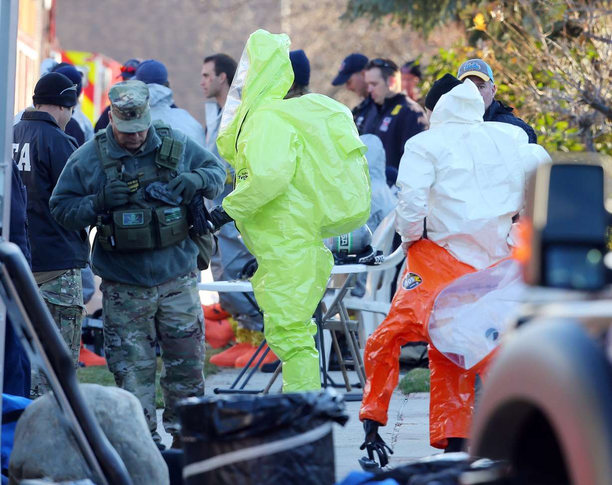 Police and DEA agents put on chemical suits as Local and federal agencies respond to a fentanyl drug bust in Cottonwood Heights on Tuesday, Nov. 22, 2016. (Scott G. Winterton, KSL)