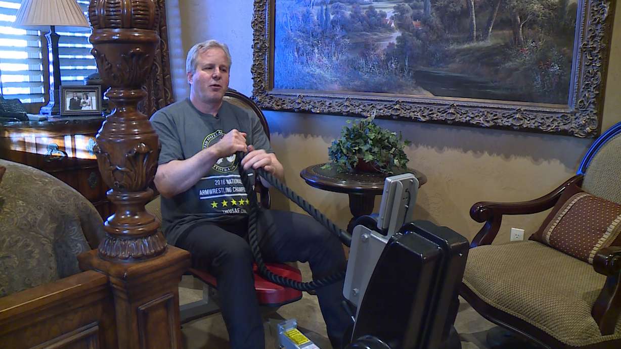 Baxter trains on his rope pulling machine, located right next to his bed. (Photo: Ray Boone)