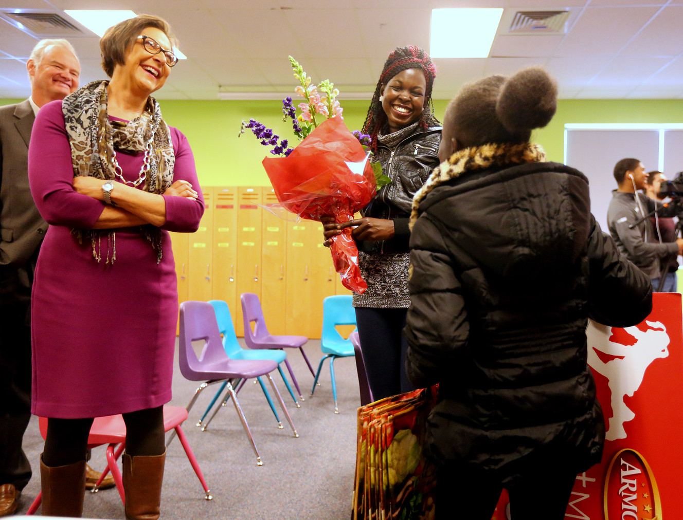 Marsha Gilford, vice president of public affairs at Smith's, talks with Rebecca Atem, and Atem's daughter, Ajoh Majok, as Rebecca Atem is honored as part of the Armour “Great Moms” campaign at the YMCA in Taylorsville on Tuesday, Nov. 29, 2016. (Photo: Scott G Winterton, Deseret News)