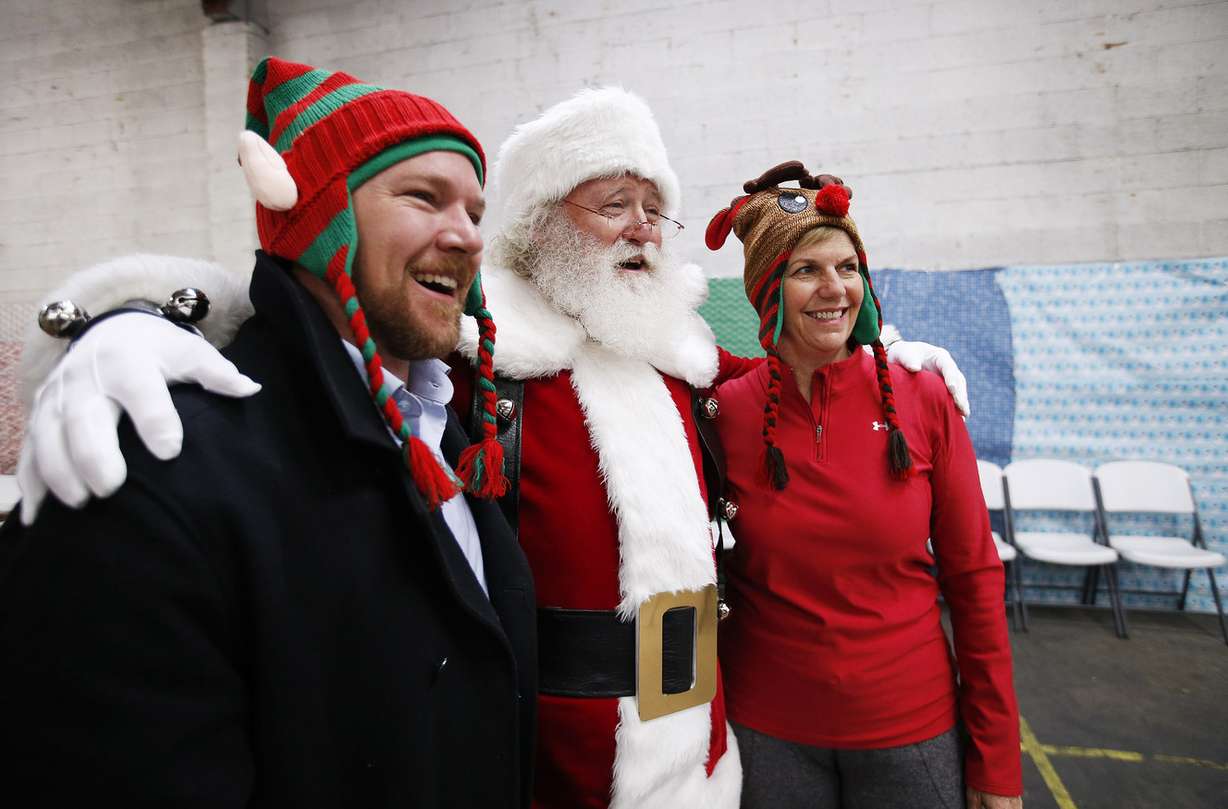 Salt Lake City Council members Andrew Johnston and Lisa Adams pose with Santa at the Candy Cane Corner Holiday store in Salt Lake City on Friday, Dec. 2, 2016. The store is in its 20th year and is open for low-income families who are participating in programs at the Road Home, Volunteers of America-Utah and the YWCA. (Photo: Jeffrey D. Allred, Deseret News)