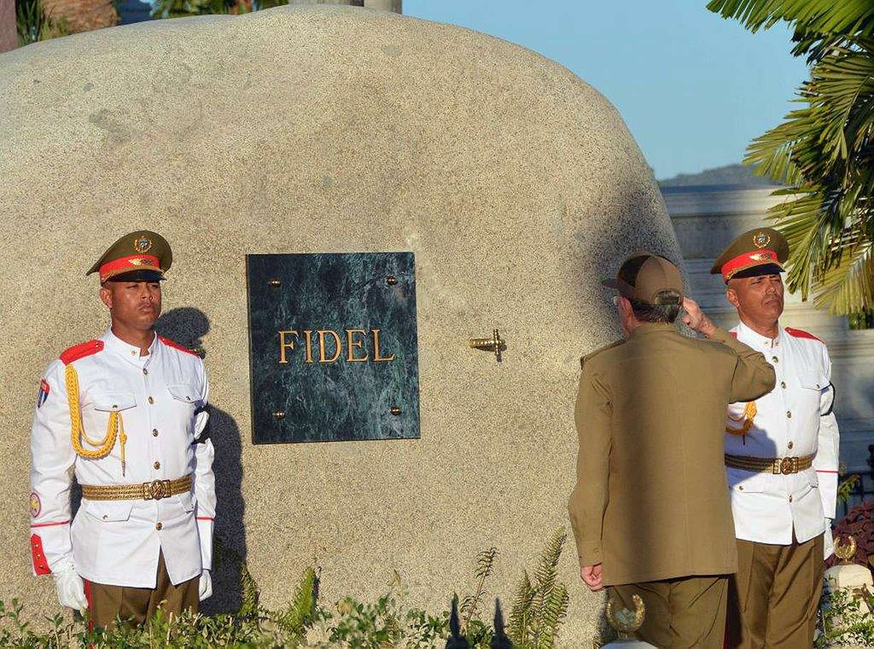 Cuba's President Raul Castro salutes at the tomb of his older brother Fidel Castro, a simple, grey, round stone about 15 feet high, at the Santa Ifigenia cemetery in Santiago, Cuba, Sunday Dec.4, 2016. Raul Castro placed the ashes in a niche in the tomb that was then covered by a plaque bearing the single name,"Fidel."(Marcelino Vazquez Hernandez/Pool Photo via AP)