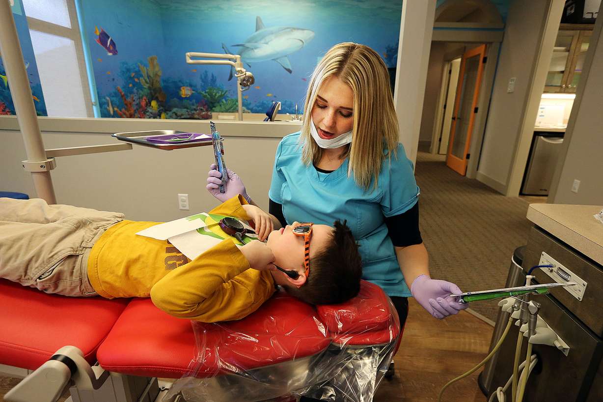 Dental assistant Celeste McHone helps Dawson McGraw choose a new toothbrush at Kidz Dental Works in Kaysville on Monday, Dec. 5, 2016. (Photo: Ravell Call, Deseret News)