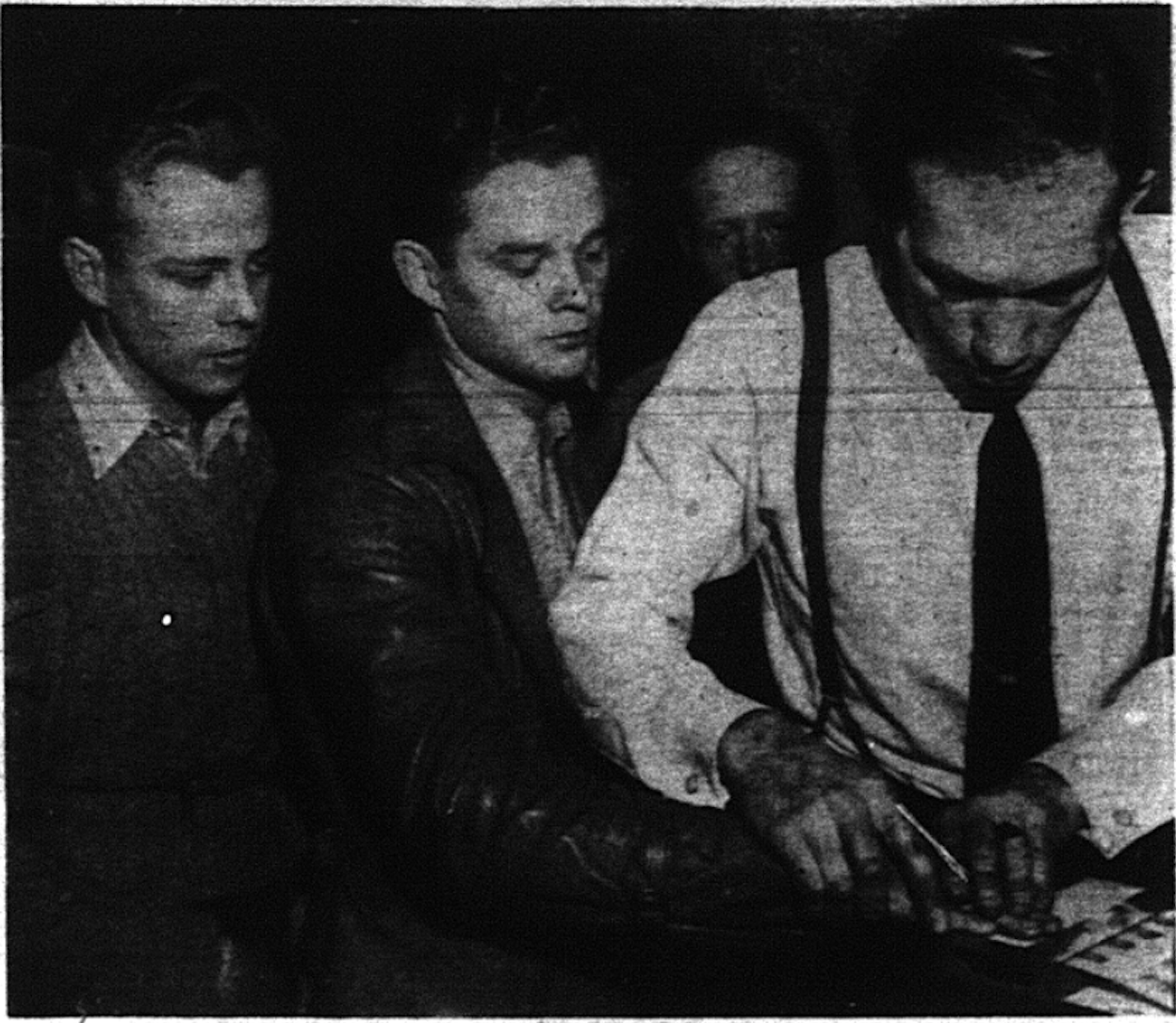 Bill Ostler is fingerprinted at Navy Recruiting Office by Chief Electrician's Mate Richard Petters as Ernest Termende awaits his turn and Bert Hare and Eldon Randol, in the background look on. (Photo: Deseret News Archives)