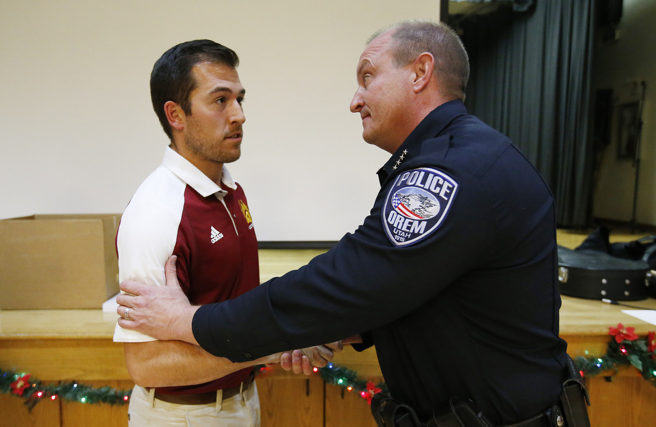 Mountain View High School football coach Jordan Blanchard, left, receives a civilian medal award from Orem Police Chief Gary Giles after helping thwart the student stabbing incident in Orem on Thursday, Dec. 15, 2016. (Photo: Jeffrey D. Allred, Deseret News)