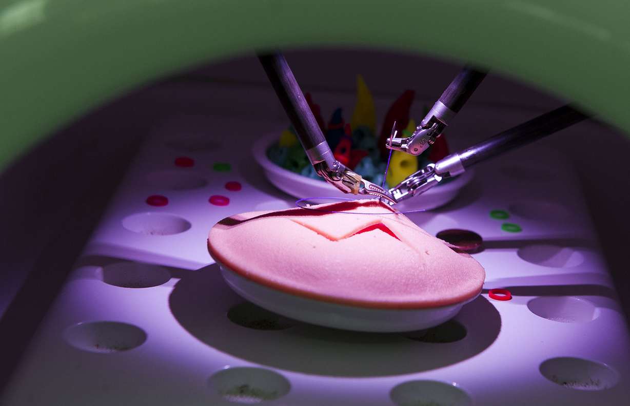 A da Vinci Xi surgery robot sutures a practice incision at St. Mark's Hospital in Salt Lake City on Friday, Dec. 16, 2016. The robot mimics a surgeon’s hand movements but with a wider range of motion using robotic arms, allowing physicians to perform complex dissections or reconstructions with a much smaller incision. As a result, patients experience less trauma, reduced pain, faster recovery times and minimal scarring. (Photo: Nick Wagner, Deseret News)