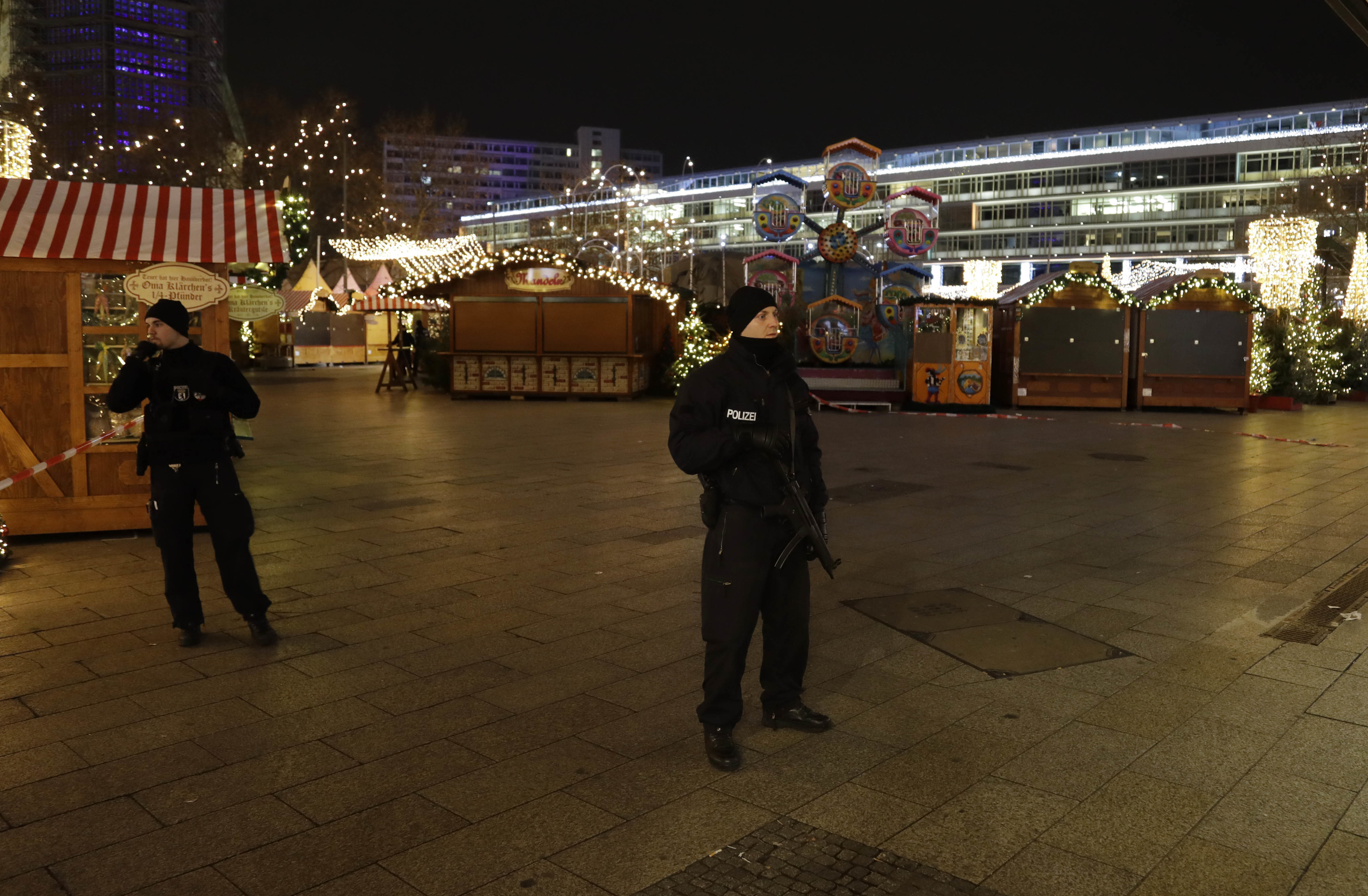 Police guard a Christmas market after a truck ran into the crowded Christmas market in Berliin Berlin, Germany, Monday, Dec. 19, 2016. (AP Photo/Michael Sohn)