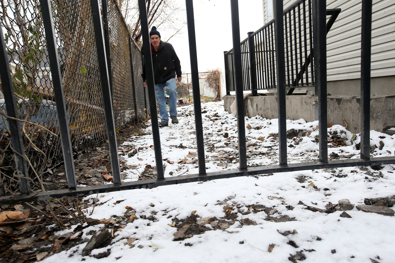 Richard Bennett walks toward a warped gate on his property in the Farm Meadows subdivision of Woods Cross on Wednesday, Dec. 21, 2016. Photo: Laura Seitz, Deseret News