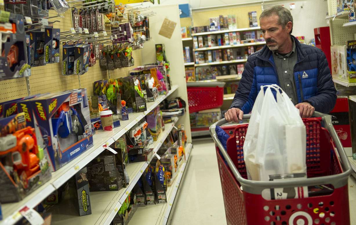 Devor Taylor looks for toys for his children while doing last-minute shopping at Target in Salt Lake City on Friday, Dec. 23, 2016. Photo: Nick Wagner, Deseret News