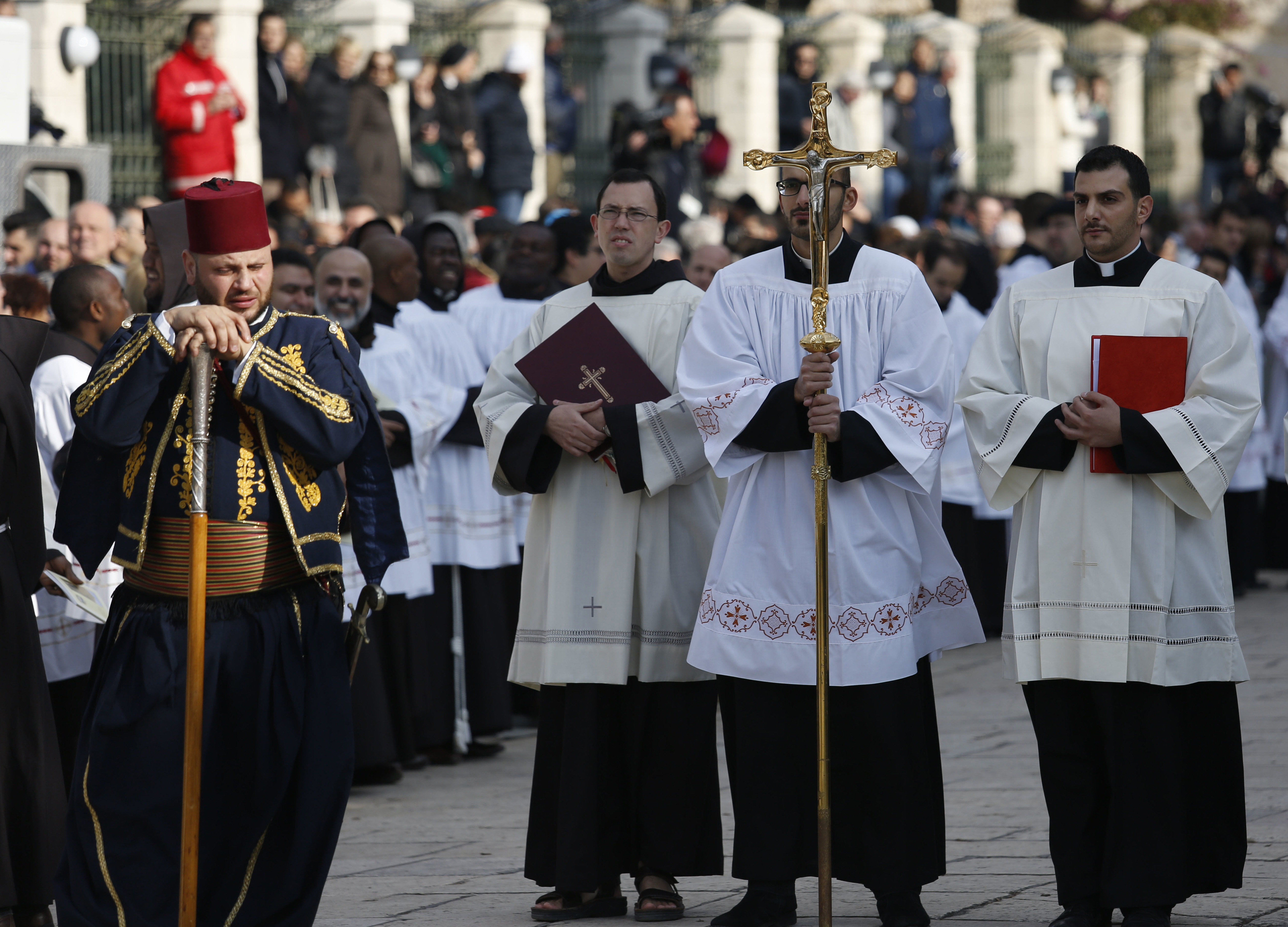 Christian clergymen waiting for the arrival of the Latin Patriarch of Jerusalem Pierbattista Pizzaballa, center, at the Church of the Nativity, built atop the site where Christians believe Jesus Christ was born, on Christmas Eve, in the West Bank City of Bethlehem, Saturday, Dec. 24, 2016. (Majdi Mohammed, AP Photo)